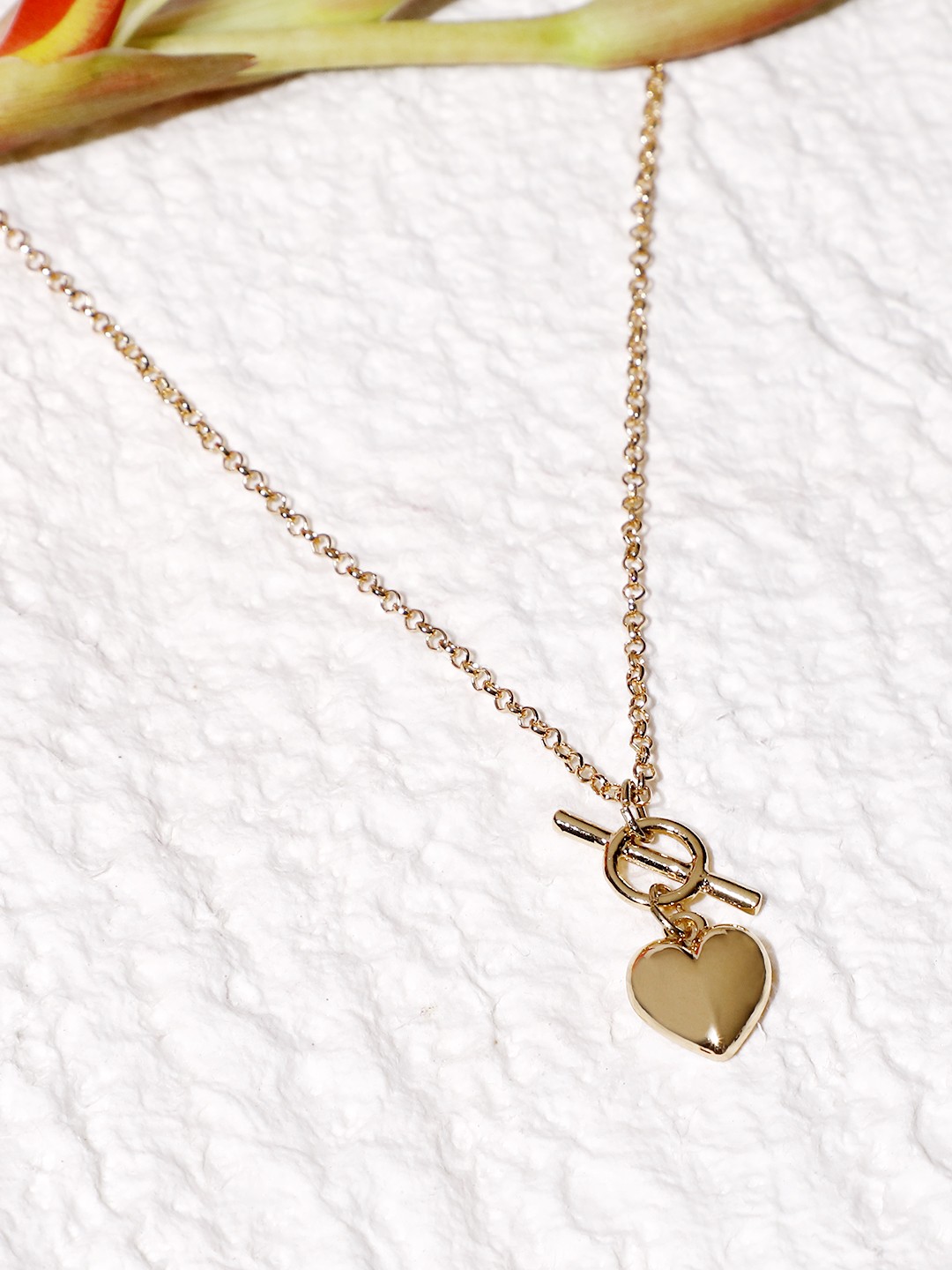 Gold toned chain with heart and toggle charm