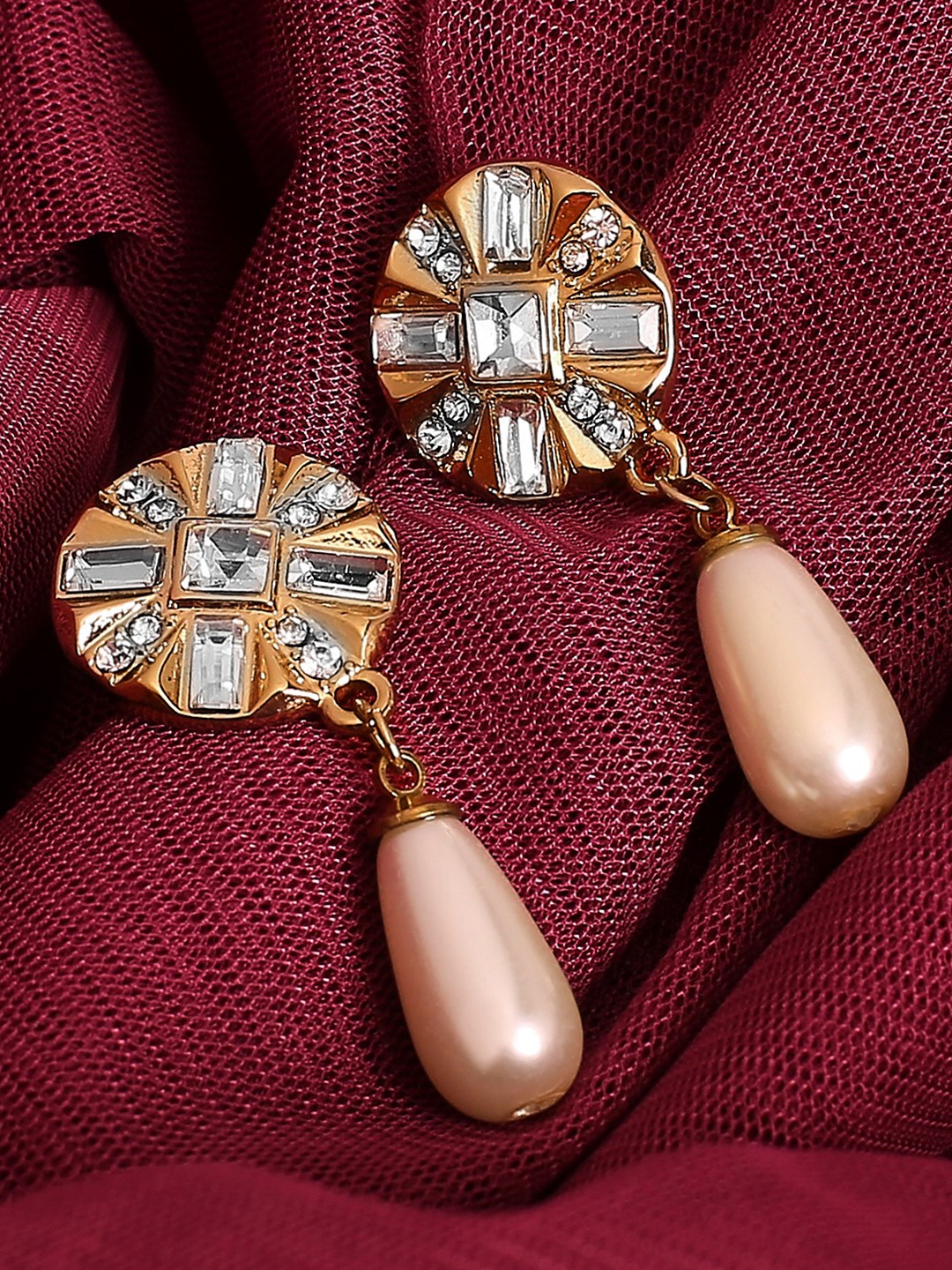 Gold toned crystal studded earrings with peach drop pearl