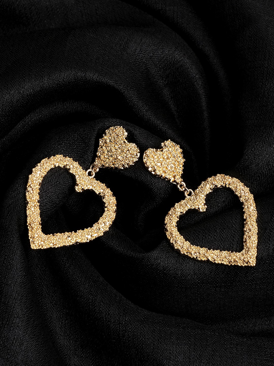Gold toned heart shaped cutout dangler earrings