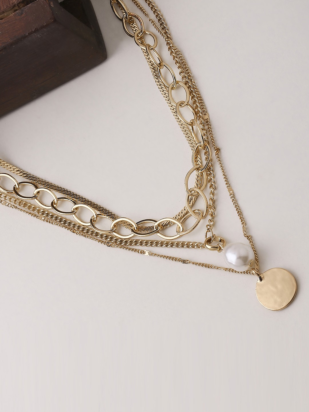 Four layered necklacewith drop pearl and and coin pendant