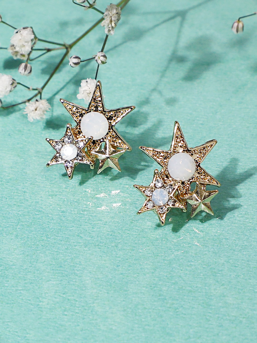 Gold toned crystal studed Tri-Star stud earrings