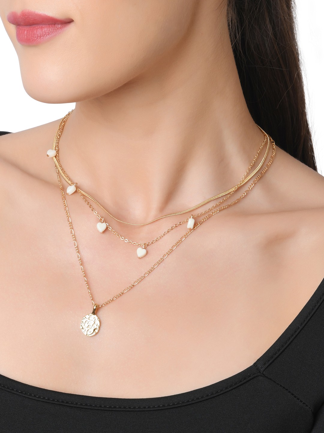 Gold toned two layered necklace with white hearts and hammered coin charm