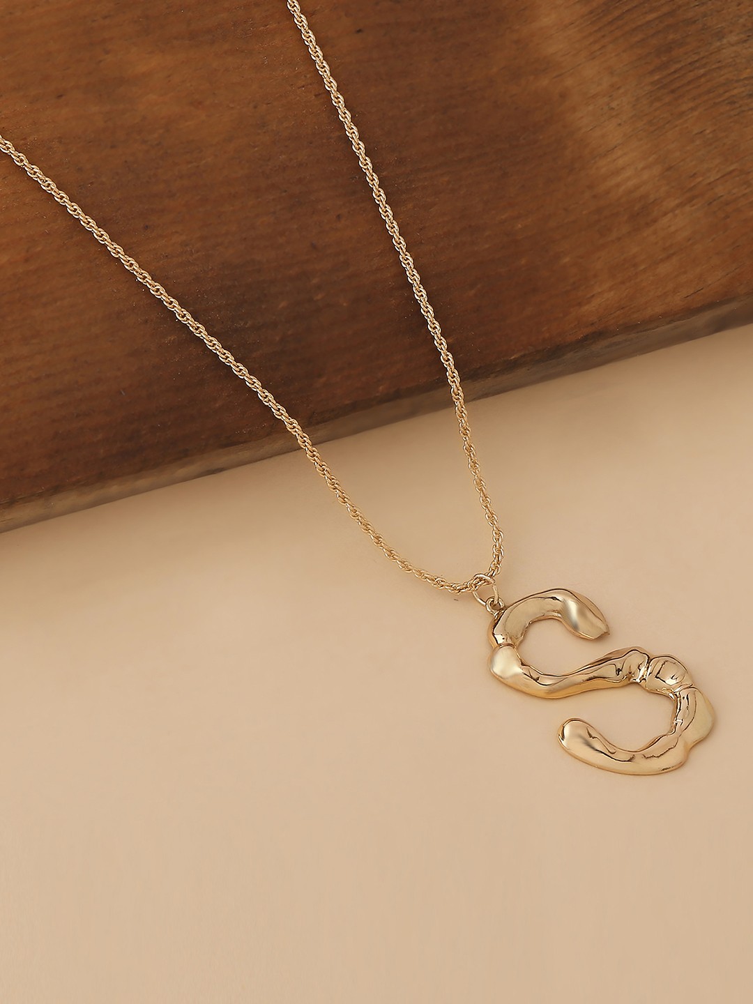 Gold toned chain with initial S pendant