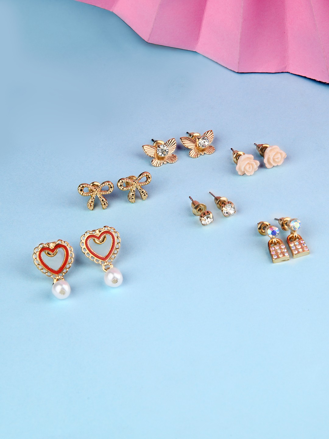 Gold toned set of 6 flower, knot, heart, butterfly, lock and stone stud pack