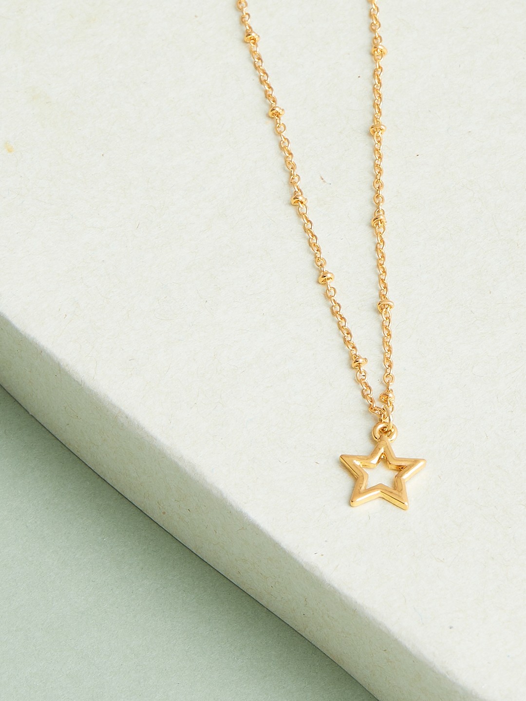 Gold toned chain with star pendant