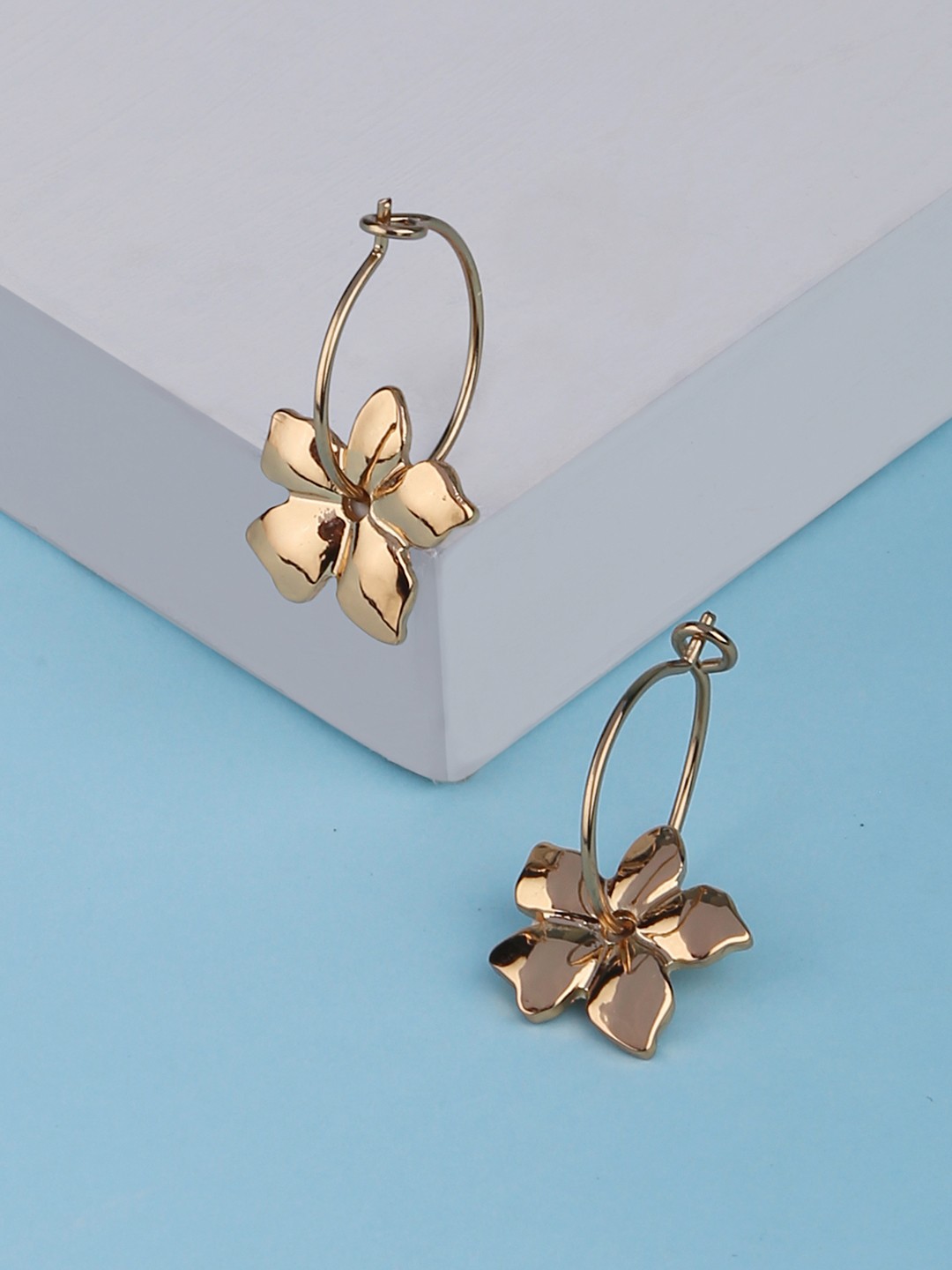 Gold toned bali earrings with flower charm