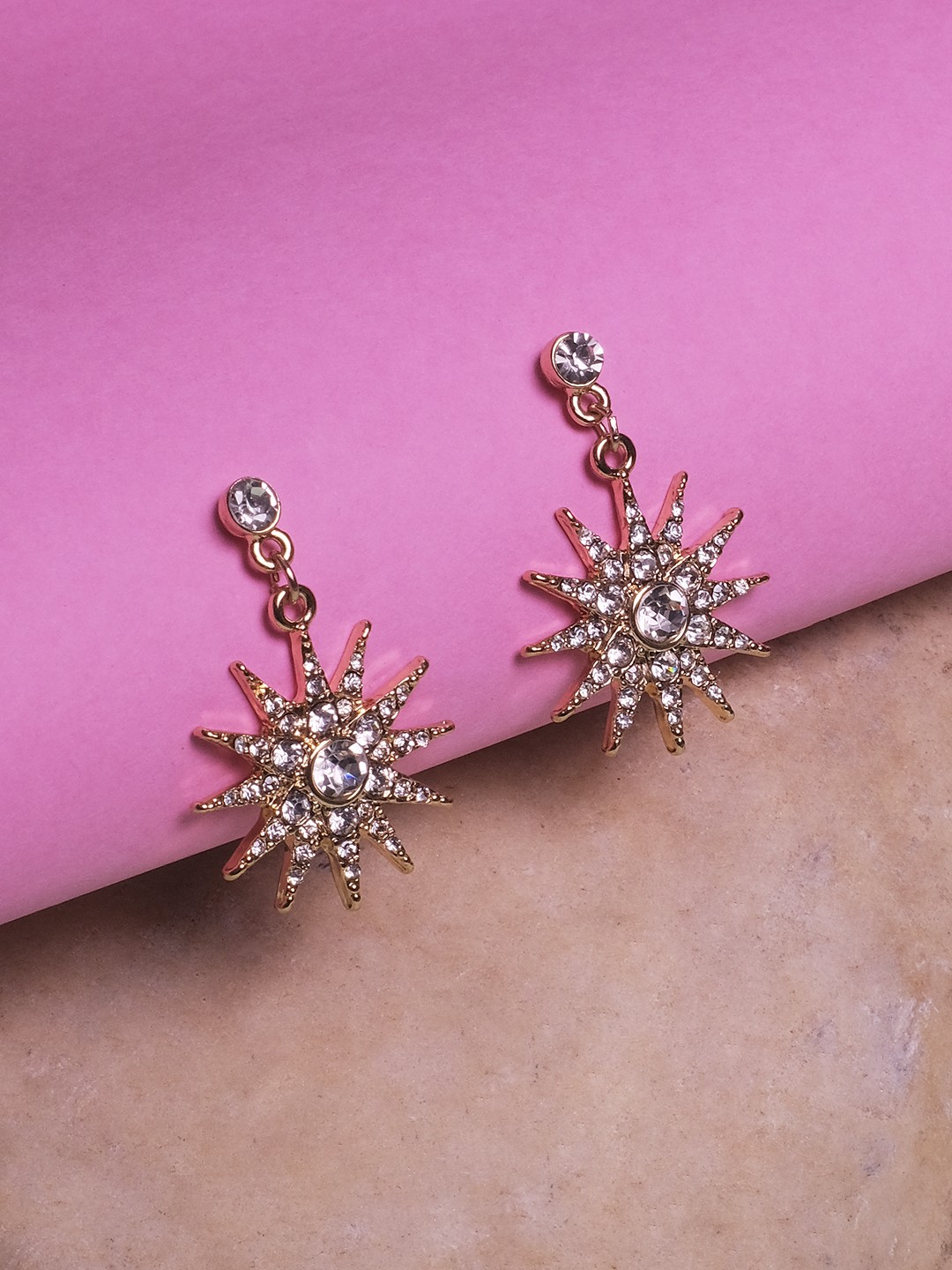 Gold toned Statement crystal studed star shaped dangler earrings