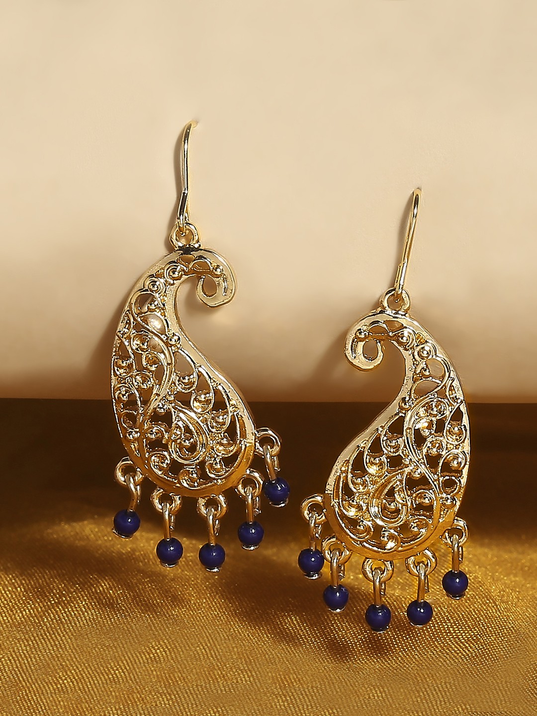Gold toned paisley shaped earrings with beads