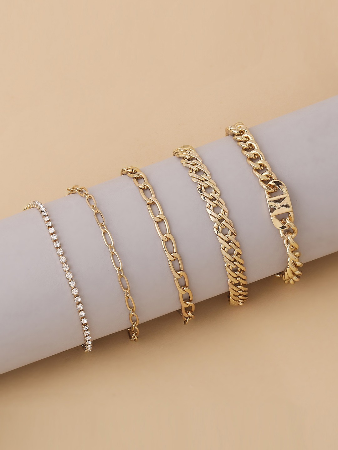 Gold toned set of five bracelet set