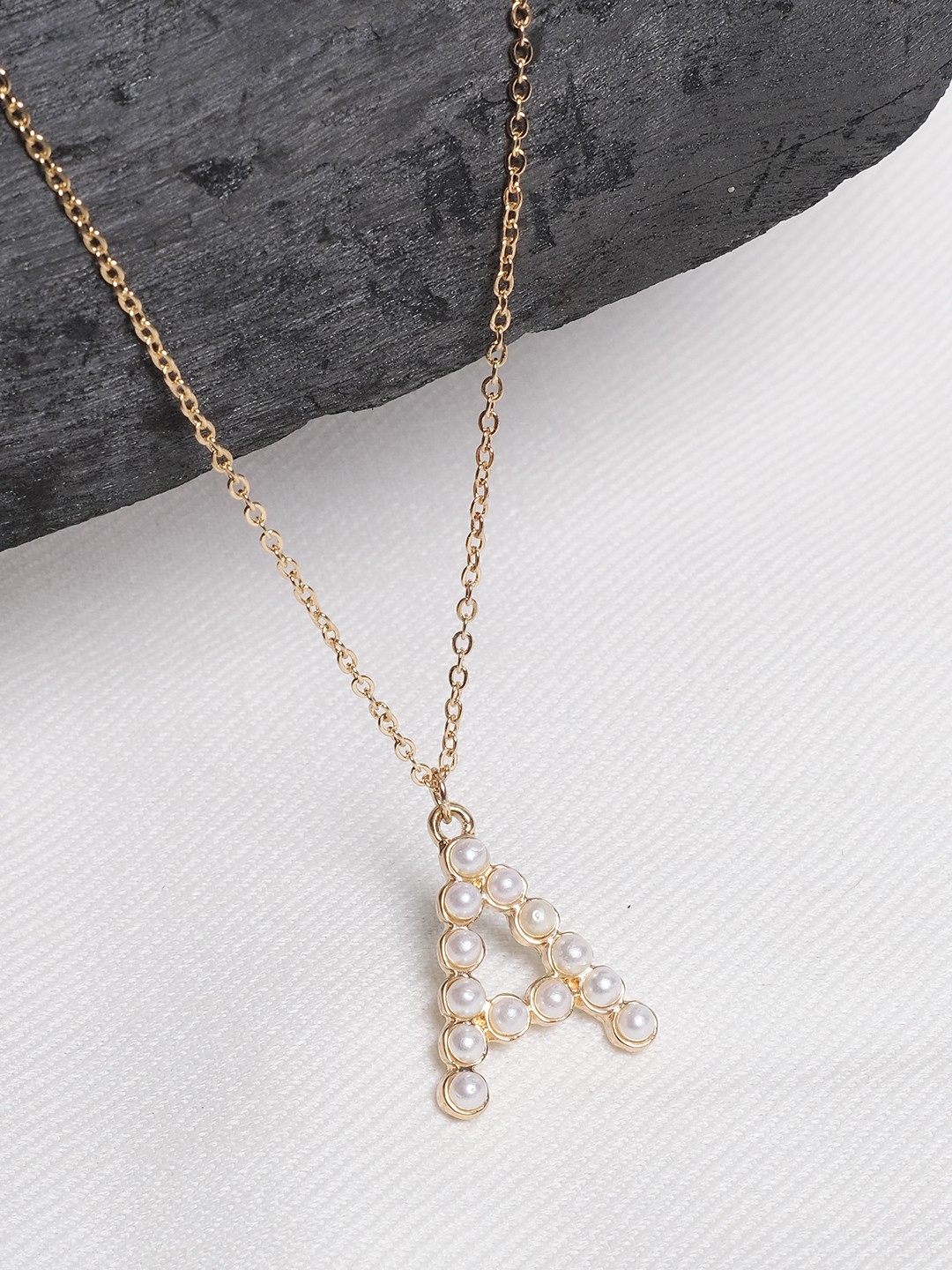 Gold toned pearl embellished initial A pendant