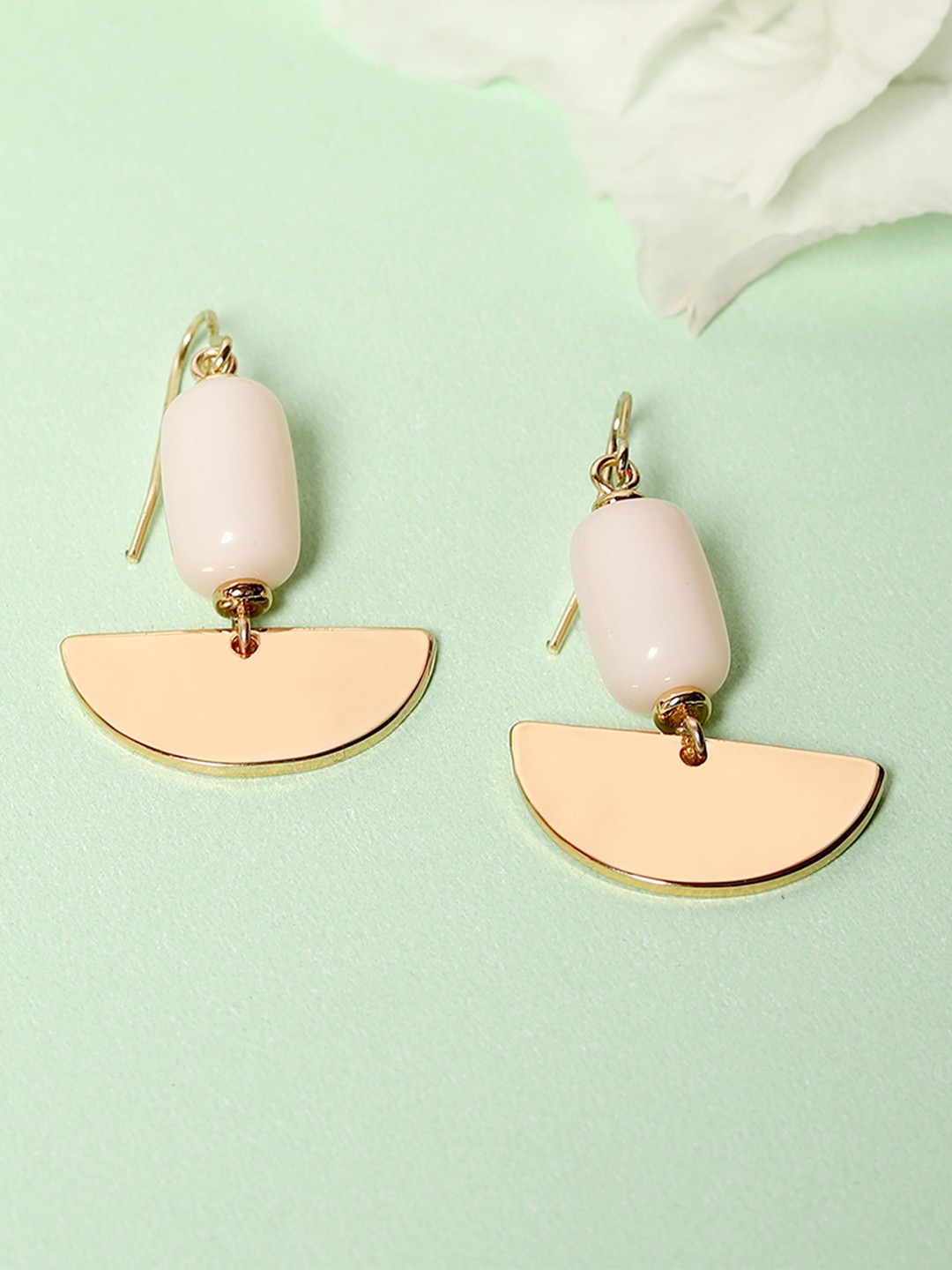 Gold tonned semi circular dangler earrings with pink stone