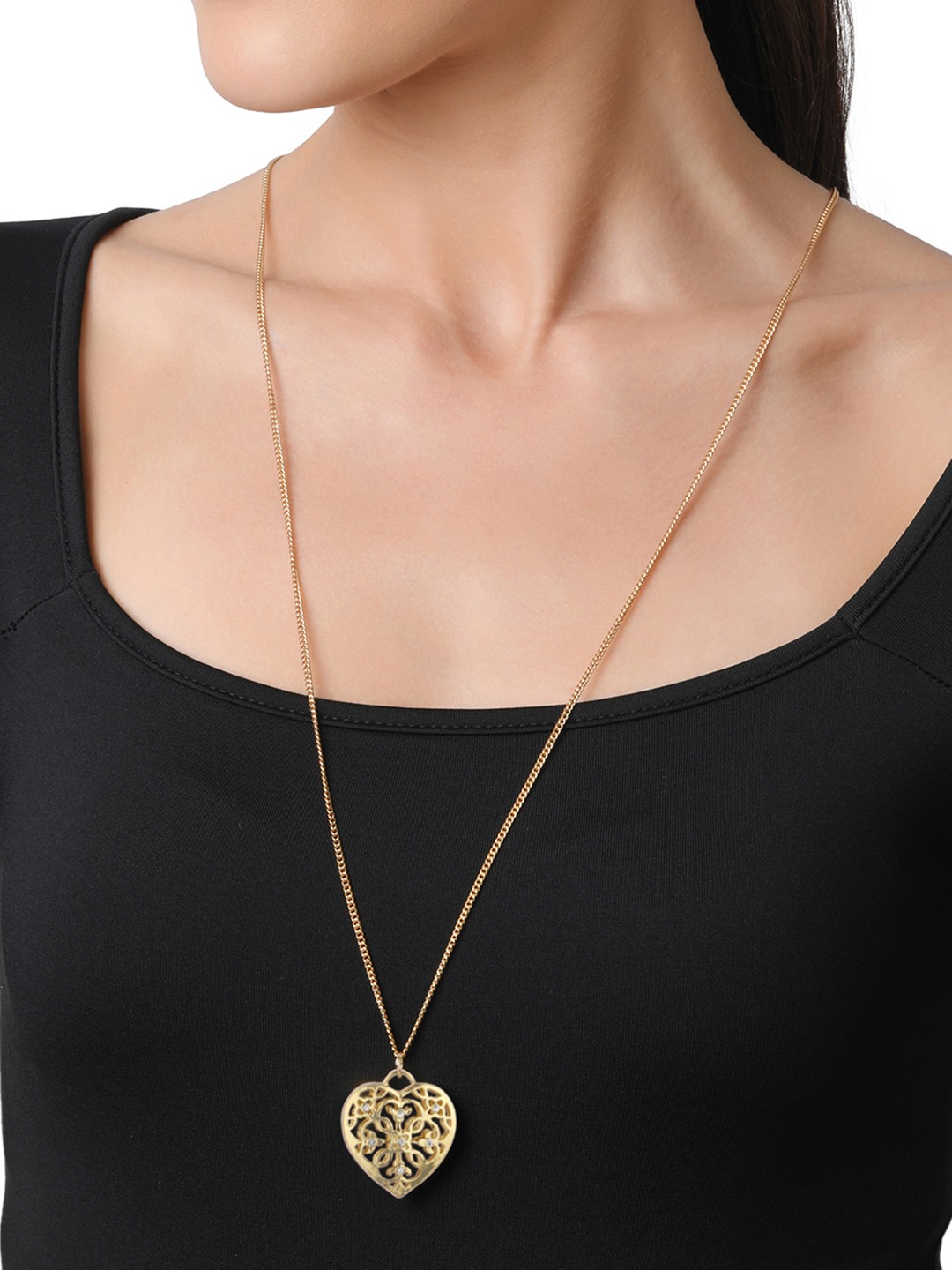 Gold toned long chain with filigree heart locket