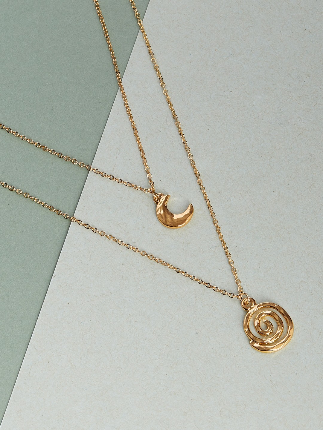 Gold toned two layered necklace with moon and spiral charm