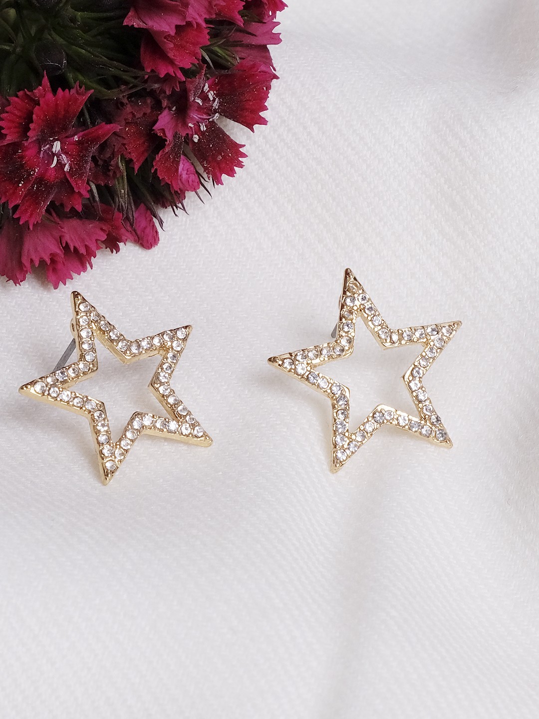 Gold toned crystal studed star shaped stud earrings