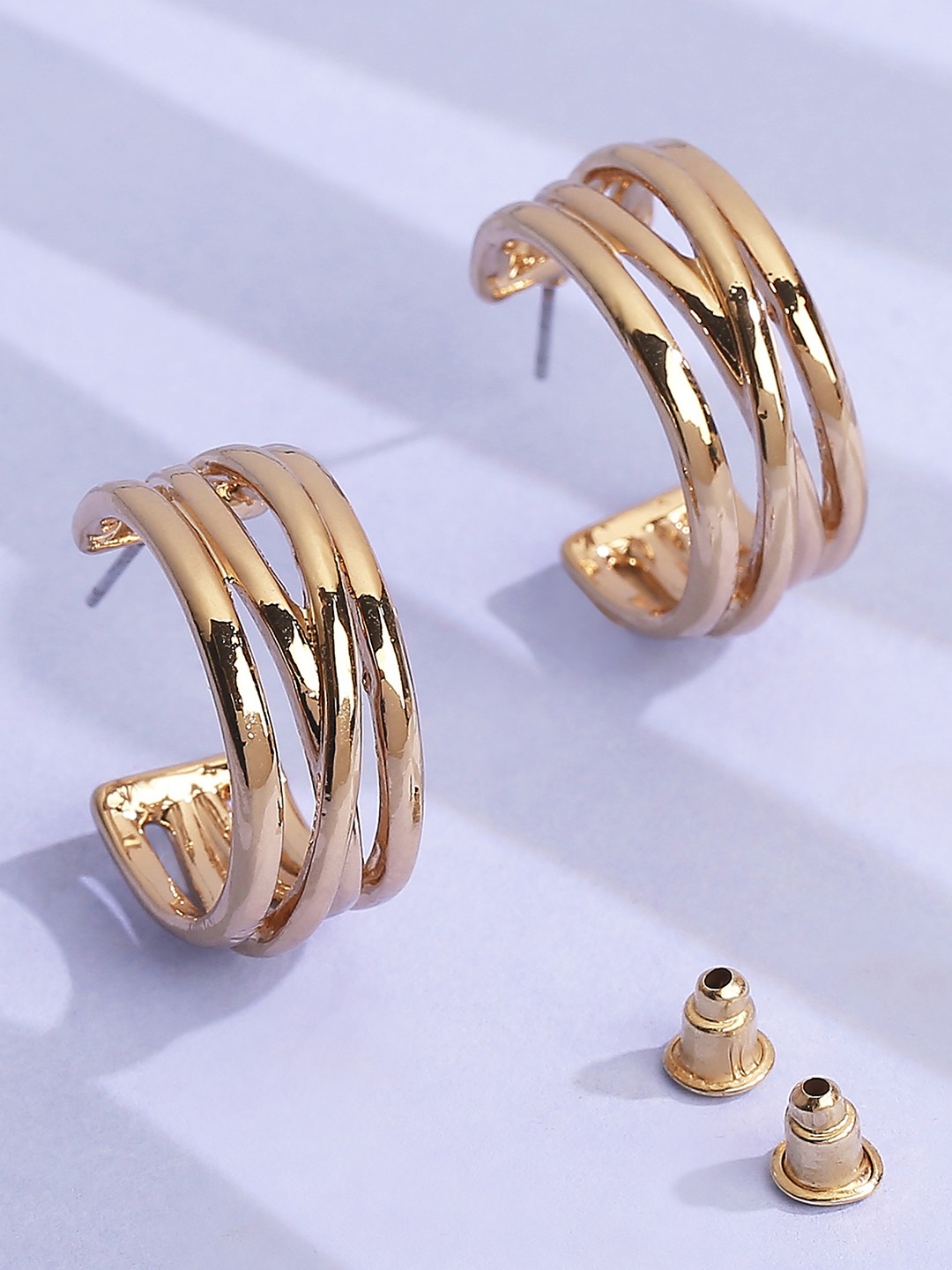 Gold toned contemporary half hoop earrings