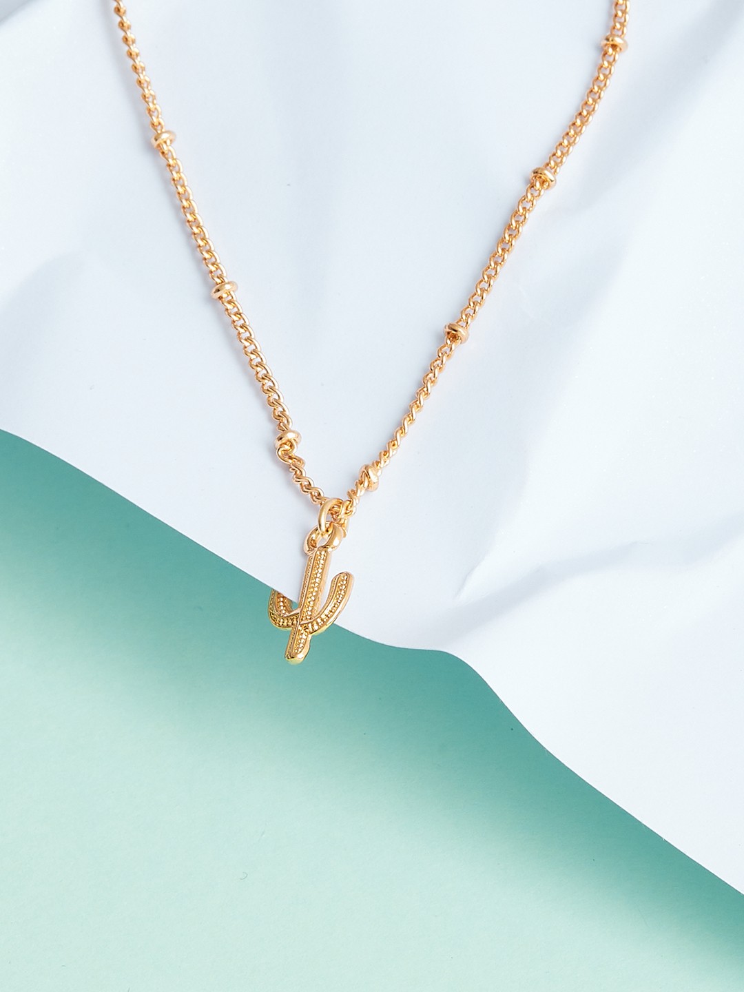 Gold toned chain with cactus charm pendant