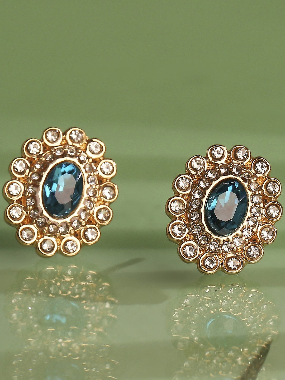 Gold toned oval stud earrings with blue stone